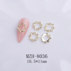 Macro shot of gold hollow flower nail charm MZH-8036 with 10.5x11mm dimensions on nail