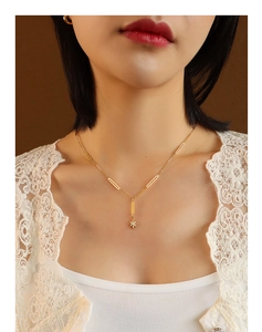 Close-up of 18K gold plated north star pendant necklace with fringe tassel on model