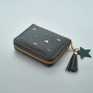 Detail of dark grey heart embroidery wallet with tassel zipper and star leather pendant