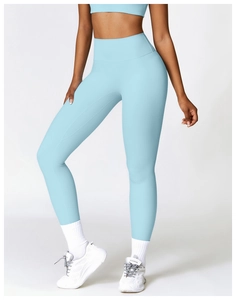 Detail of high-waist light blue seamless yoga leggings with compression fabric