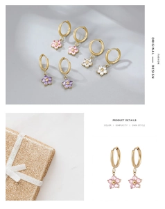 Detail view of floral hoop earrings in pink, purple, and white with a gold-tone gift box