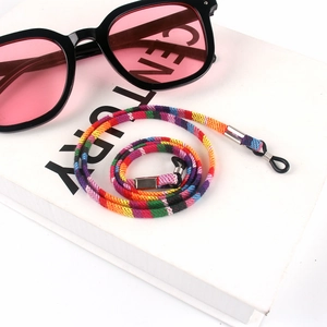 Detail of bohemian hand-woven glasses strap with metal buckles on white background