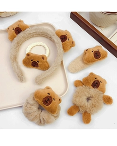 Detailed set of brown bear plush headbands, hair ties and clips on a beige tray