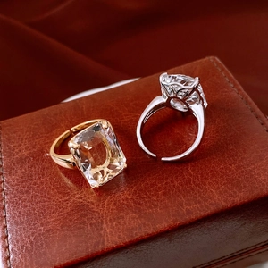 Detail of 14k gold plated square cut crystal rings on vintage leather jewelry case
