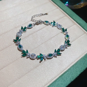 Detail of silver leaf bracelet with marquise emerald gems and sparkling zircons