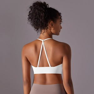 Detail of white sports bra featuring a Y-shaped back design and wide elastic band