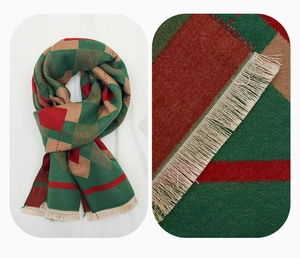 Macro detail of red and green diamond pattern scarf fabric with fine tassel fringe