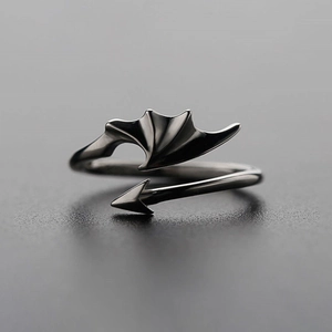 Macro detail of black gothic devil wing ring featuring adjustable arrow tail design