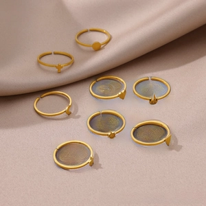 Set of 8 gold sun moon and star open rings displayed on a soft beige fabric background