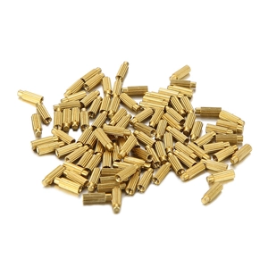 Solid brass cylindrical hardware fasteners with knurled non-slip texture on white surface