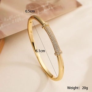 Luxurious 18K gold plated bamboo bracelet with zircon accents on a beige background