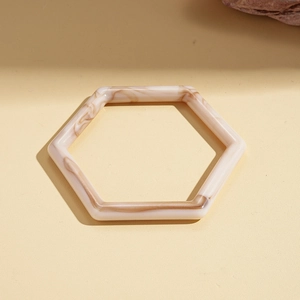 Close-up of hexagonal acetate resin bracelet featuring vintage marble texture patterns