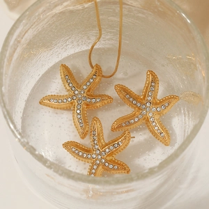 Golden starfish jewelry set with sparkling crystals in water, stainless steel earrings and necklace