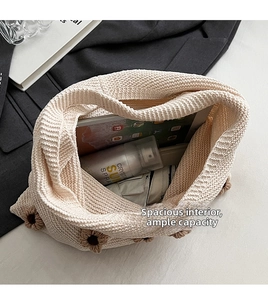 Detail showing the spacious interior of the cream knit tote bag with flower pattern