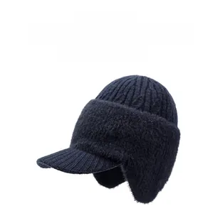 Detail of dark blue knitted baseball cap featuring thick warm fleece ear flaps and trim