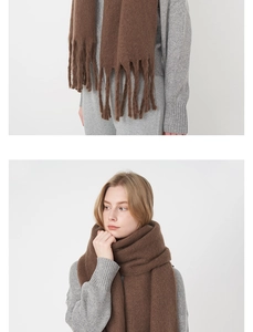 Detail of brown mohair scarf with thick knit tassels and soft textured material