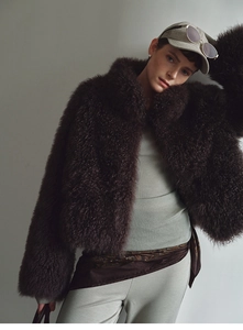 Detail of deep brown faux fox fur vest with stand collar and soft textured fibers