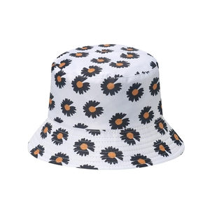 Detail of white bucket hat featuring black daisy prints and reinforced brim stitching