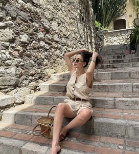 Women's chic beige linen vest and shorts set with a brown leather belt detail