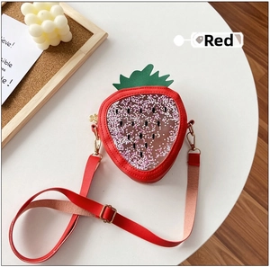 Macro detail of red strawberry bag featuring a clear window filled with sparkly stars
