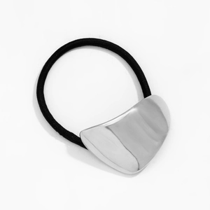 Detail of high-elastic black hair tie with polished silver curved metal geometric charm