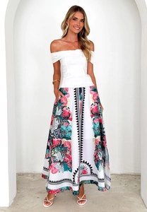 Detail of high waisted floral maxi skirt with vibrant patterns and elegant drape design