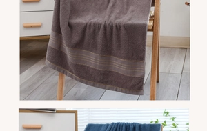 Detailed texture of thick absorbent cotton bath towels in brown gray and deep blue colors