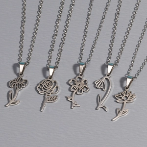 Five silver stainless steel necklaces featuring different flower pendants on grey background