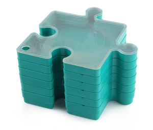 Vertical stack of blue puzzle-shaped storage boxes with semi-transparent lids on white base