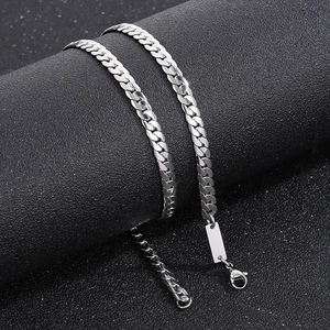 Detail of silver Cuban link chain with lobster clasp and engravable rectangular metal tag