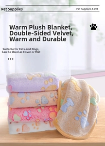 Detail of coral fleece pet blankets with colorful paw prints and bone patterns