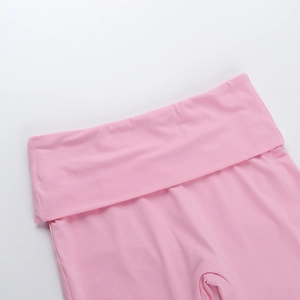 Close-up detail of pink knitted pants featuring a high-waisted folded design with stitching