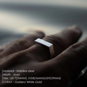 Minimalist 5mm stainless steel band ring for men shown on finger with ocean backdrop