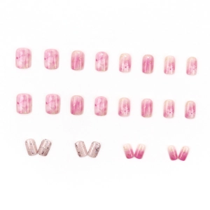 Pink camellia press-on nails set with floral art, glitter, and gradient designs