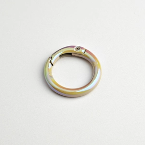Close-up of circular alloy spring ring with rainbow iridescent electroplated finish
