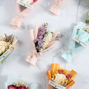 Mini artificial babys breath bouquets in colorful paper wrap with various roses