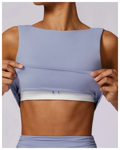 Detail view of double-layer yoga vest with built-in mesh bra in hazy blue and light purple