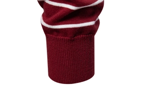 Macro detail of ribbed cuff on men's striped burgundy and white knit sweater