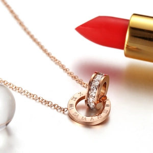 Close-up of rose gold Roman numeral double ring necklace with sparkling crystals