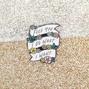Enamel ribbon brooch with daisies and I Do What I Want text on a glitter background