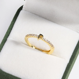 Detail of an 18k gold plated adjustable ring with letter P charm in a green velvet box