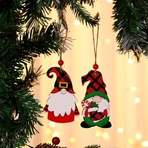 Detail of wooden Christmas gnomes with plaid hats hanging on a festive tree branch