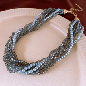 Detail of multilayer grey pearl and crystal bead necklace with gold lobster clasp closure