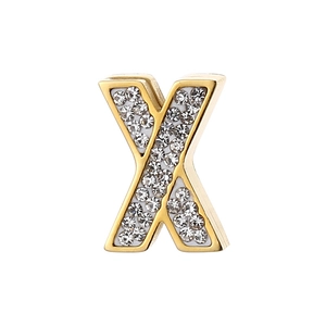 Macro detail of a golden X-shaped pendant with white enamel and sparkling rhinestones