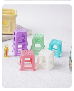 Macro view of colorful miniature plastic stool models for dollhouse decor and micro scenes