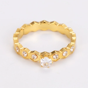 Macro detail of gold honeycomb ring with sparkling round cubic zirconia and pavé diamonds