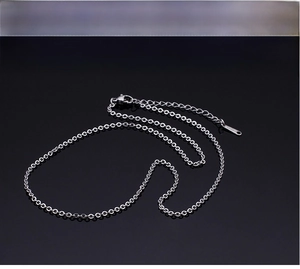 Detail of stainless steel O-chain necklace with adjustable lobster clasp on black background