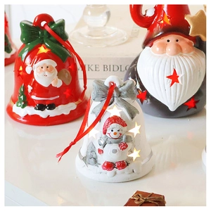 Close-up of lighted Santa bell ornaments and snowman figurines with star cutouts