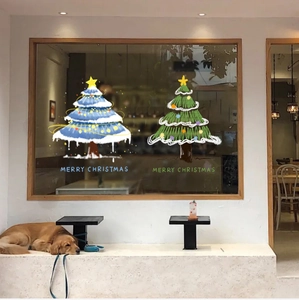 Cozy cafe window display with blue hand-drawn Christmas tree static stickers and pet dog