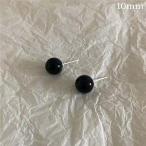 Detailed view of 10mm black agate stud earrings with sterling silver needles